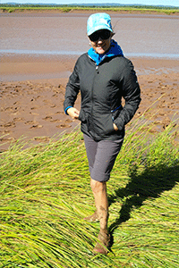 Julia McElgunn, P.Geo., stands in front of a river bed.