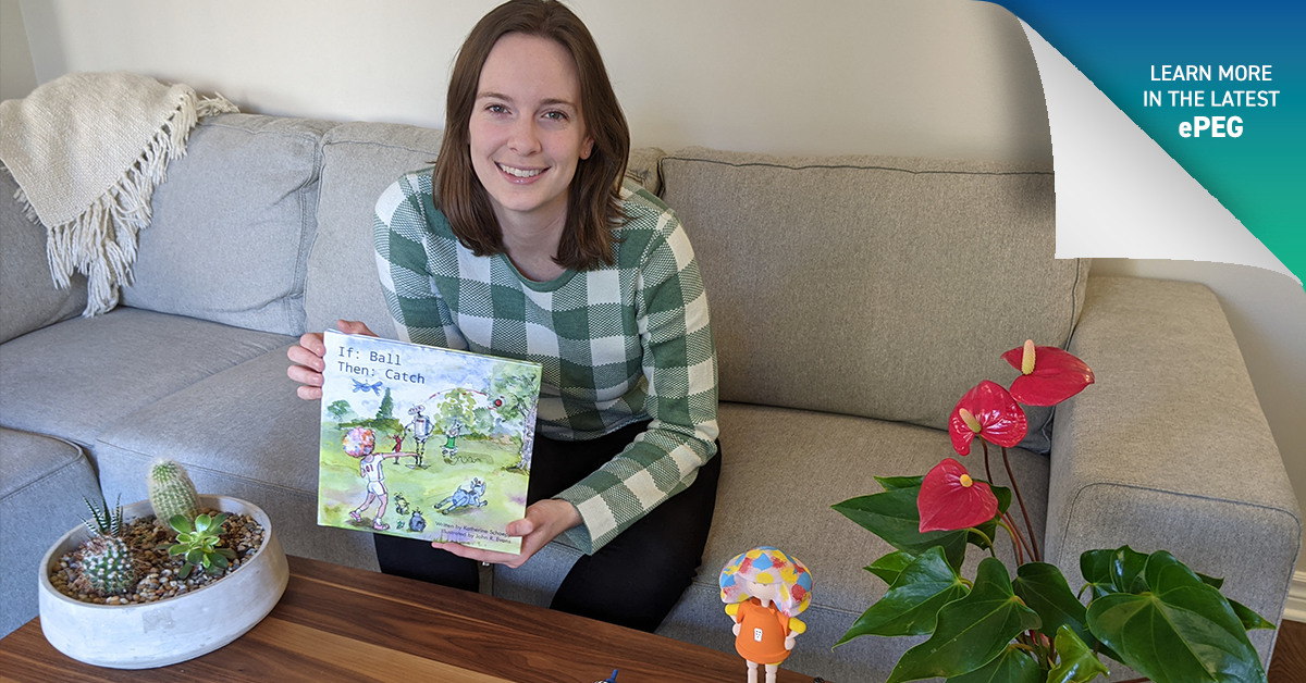 Katherine Schoepp, P.Eng., holding a copy of the book 'If: Ball, Then: Catch' next to a 3D print of the main character of the book