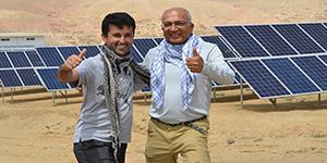 Faruq and contractor infront of solar panels