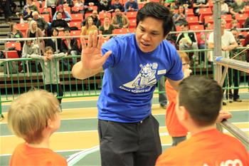 APEGA volunteer high fives students at the Edmonton Science Olympics