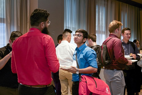 Networking events give you the chance to connect with peers and industry professionals A social event with two young adults talking together in the foreground